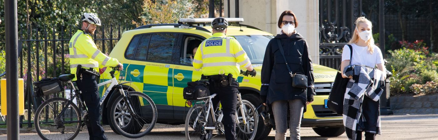 omWen wearing masks, police officers on bikes and ambulance on Pall Mall during COVID-19