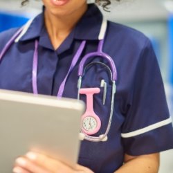 Black nurse in purple uniform