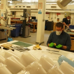 Technicians creating P.P.E. visors