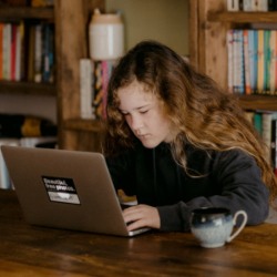 Girl working at laptop. Credit: Annie Spratt (Unsplash). 