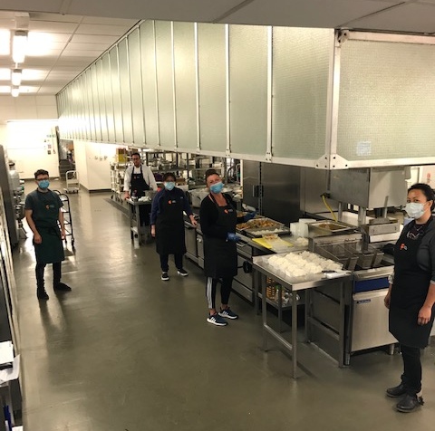 Catering team helping make and deliver food to those in need.