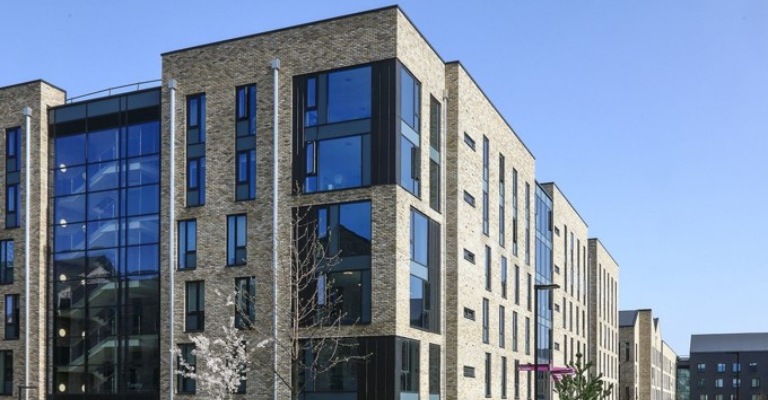 The outside of a modern student accommodation building.