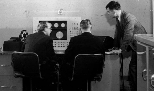 Alan Turing working with a computer