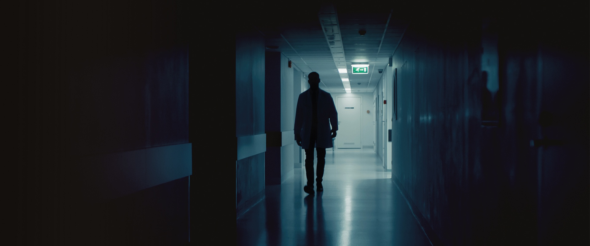 Medic walks down a hospital corridor 