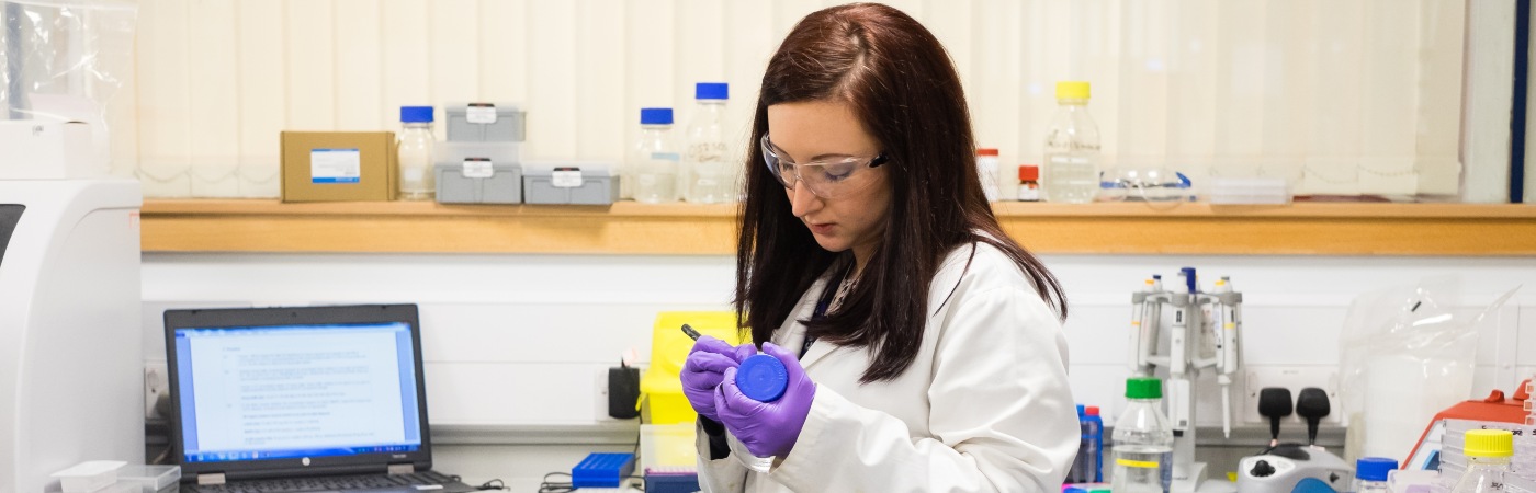 Researcher labelling a bottle