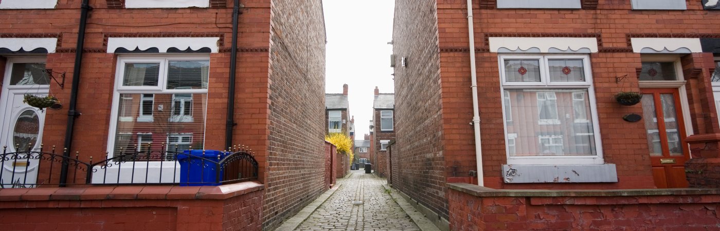 Terraced houses separated by an alley way in Greater Manchester.
