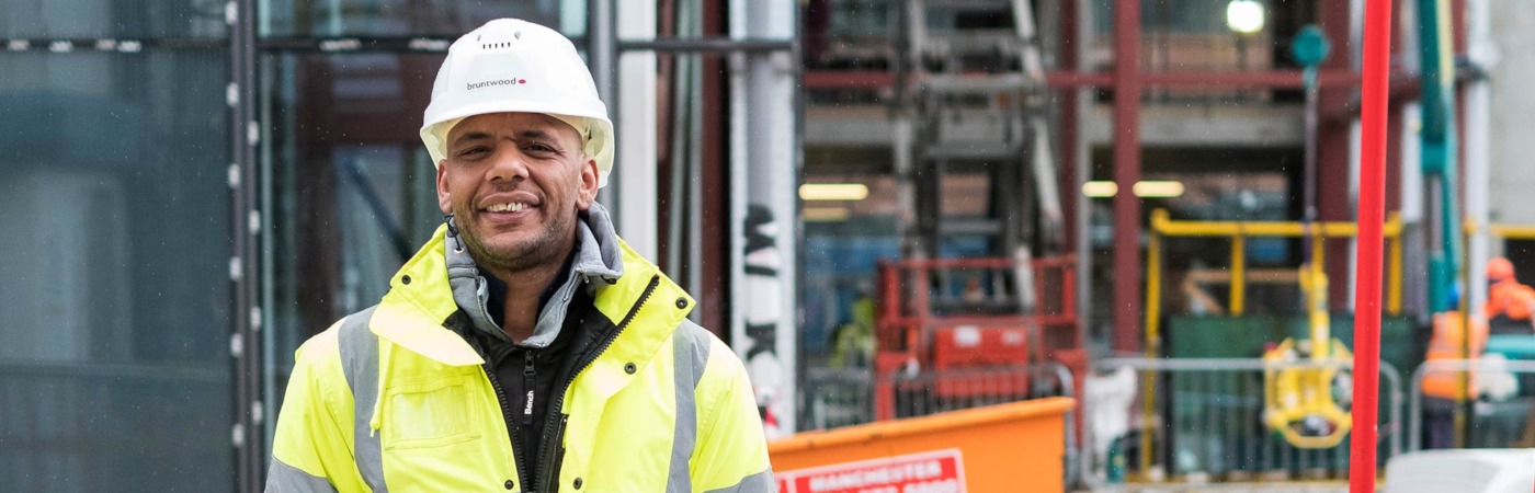 A builder smiling at the camera