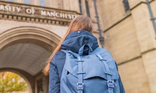 Back of a student with a backpack