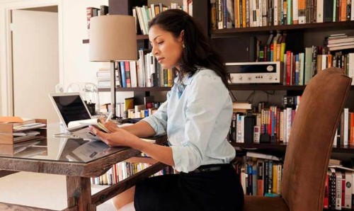 Woman at desk working from home.