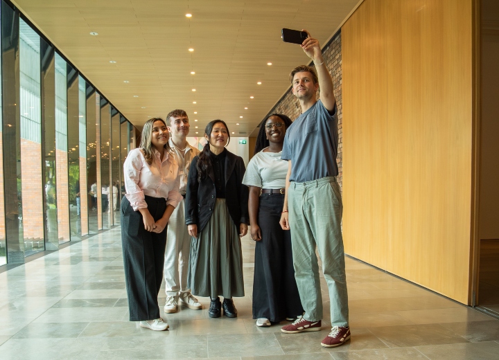 A group poses for a selfie in the Whitworth