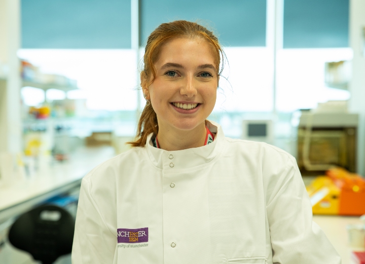 Woman smiling in her lab coat