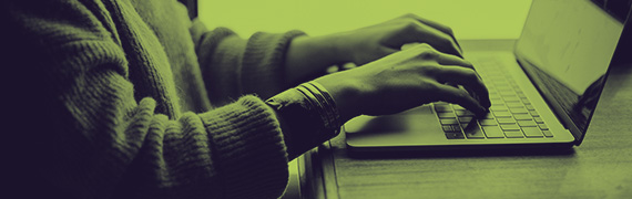 Person typing on a laptop at a desk