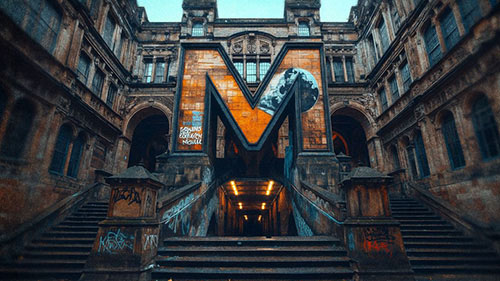 University of Manchester arched entrance with gothic architecture and stained-glass windows.