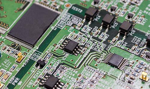 A close-up of a green computer motherboard.