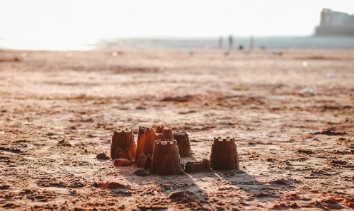 Sandcastle on a beach. Credit Unsplash