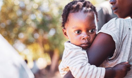 Woman carrying her baby in Africa