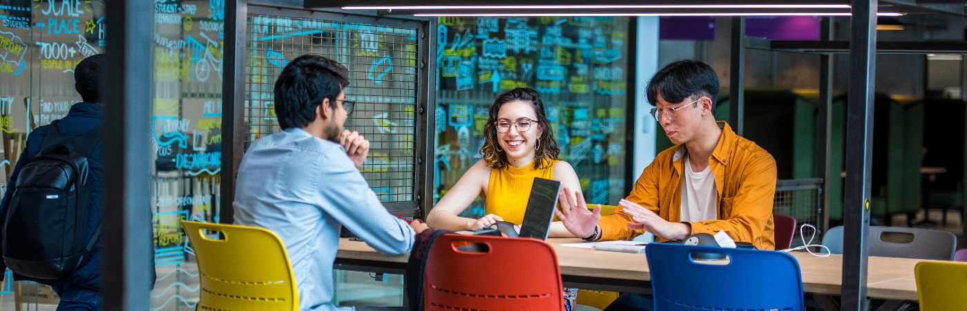 Three people working together with laptops 