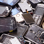 A pile of old and broken mobile phones.