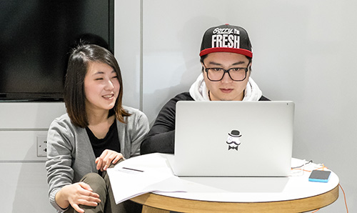 Students working at a computer in Learning Commons