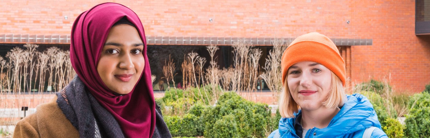 Two students facing the camera outside the Whitworth art gallery