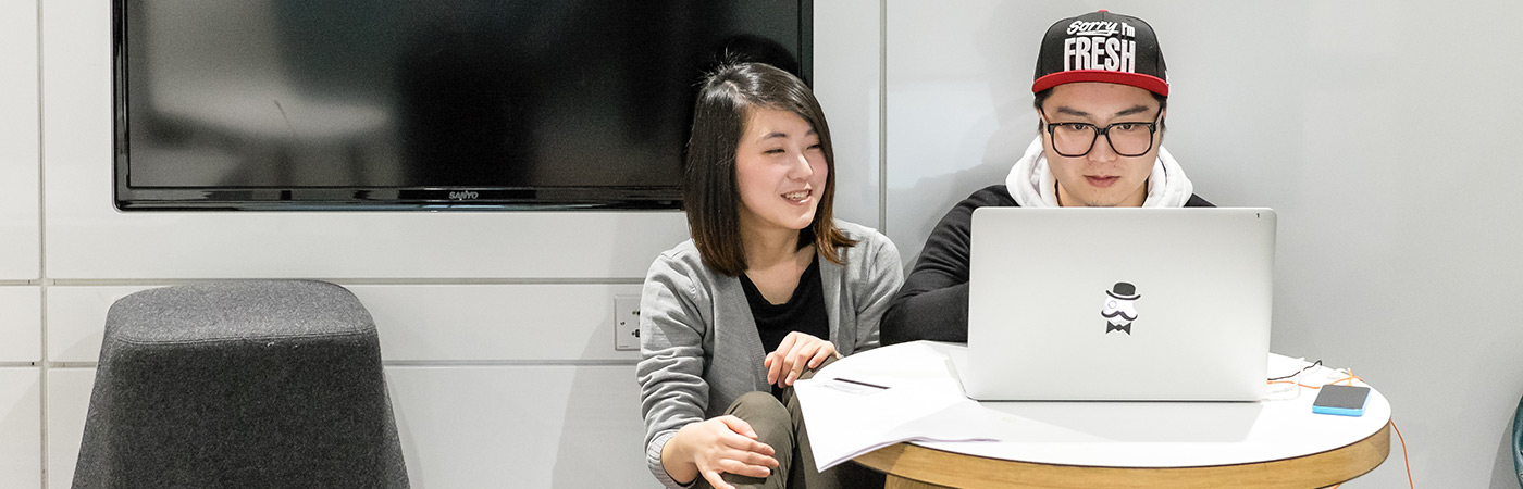 female and male student studying at computer in learning commons