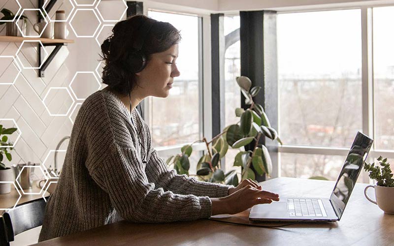 A person typing on a laptop keyboard