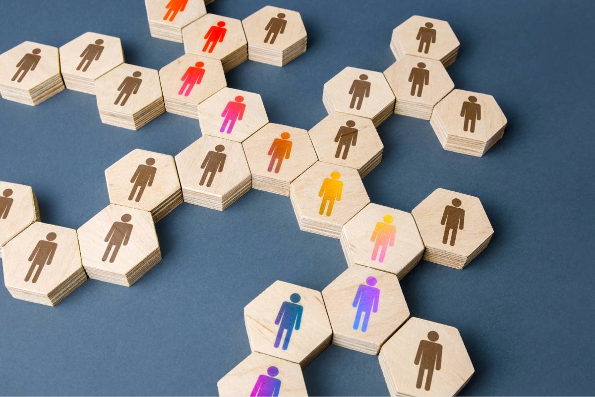 connected wooden blocks with male and female figures representing teamwork