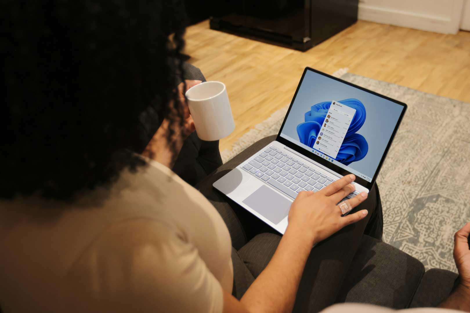A woman with a coffee using Microsoft 365
