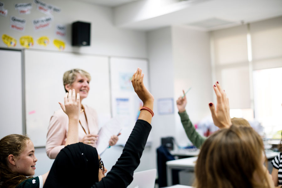female teacher sat with students