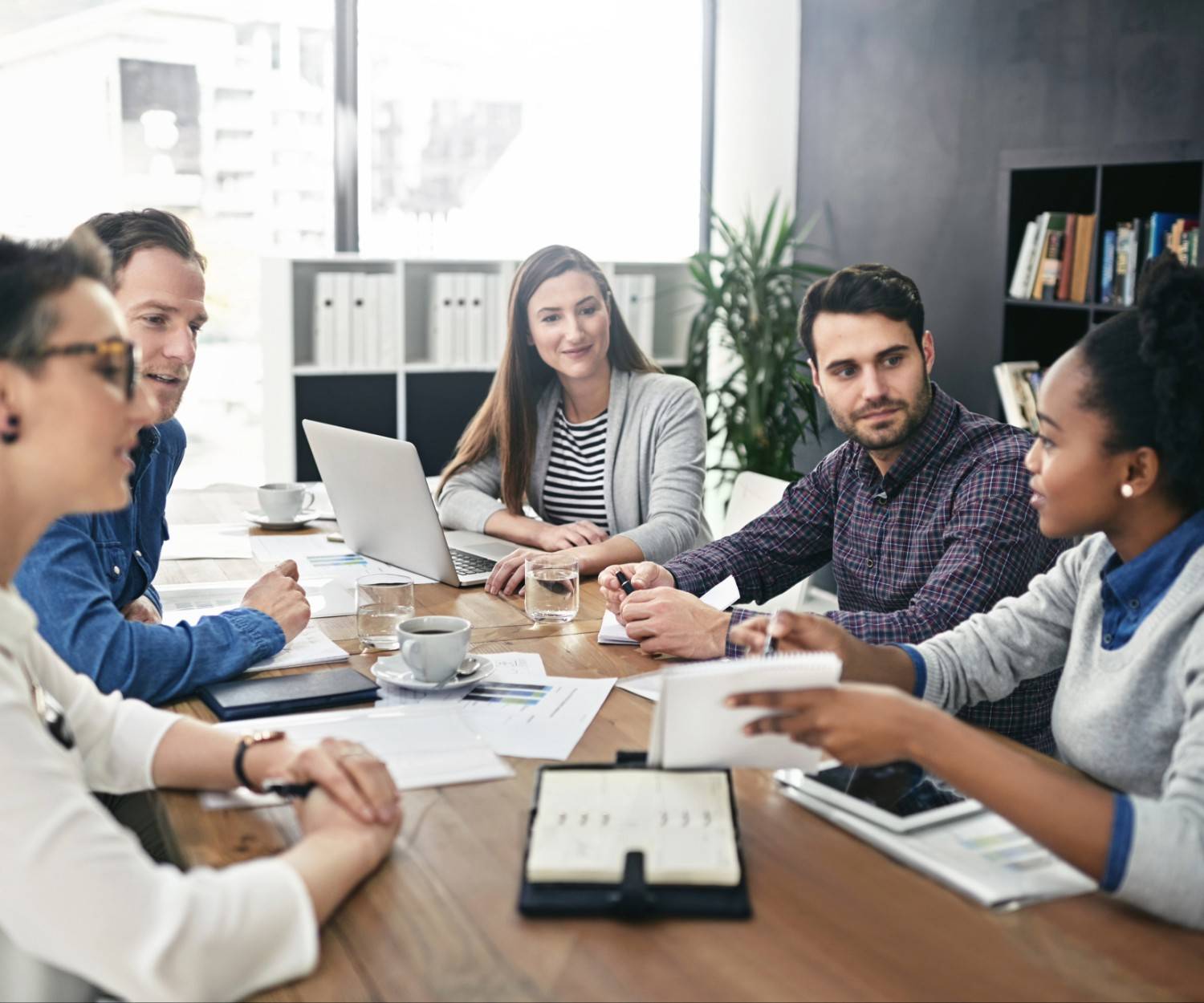 young female speaker speaking around a meeting table