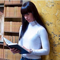 Student reading a book as part of her postgraduate studies.