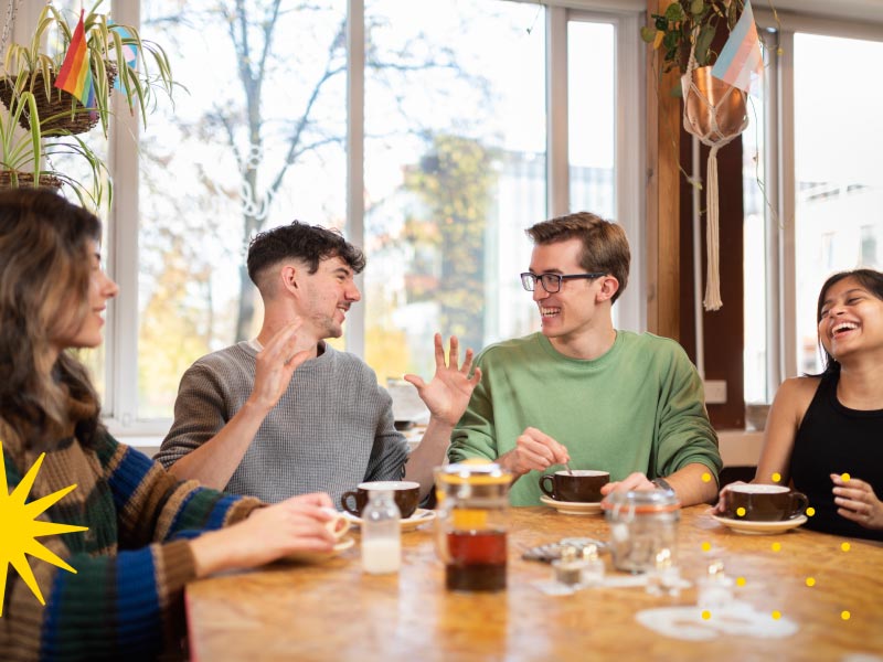 Group of students sat chatting and laughing 