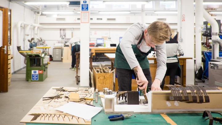 Architecture student working on model in workshop