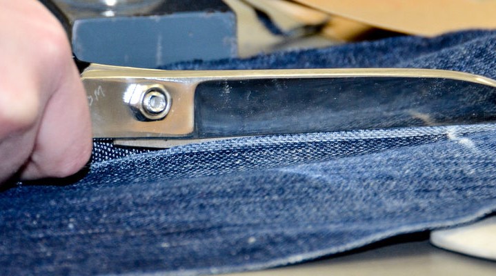 Scissors cutting jeans 