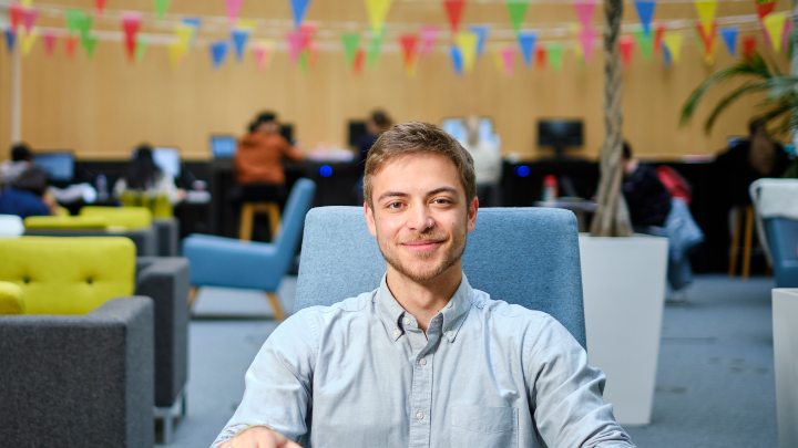 Student sat in atrium with colourful bunting