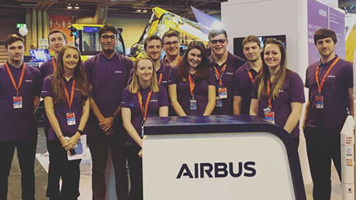 Group of students smiling at Airbus stand
