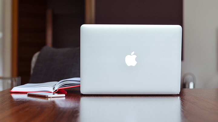 Apple Mac laptop on a table.