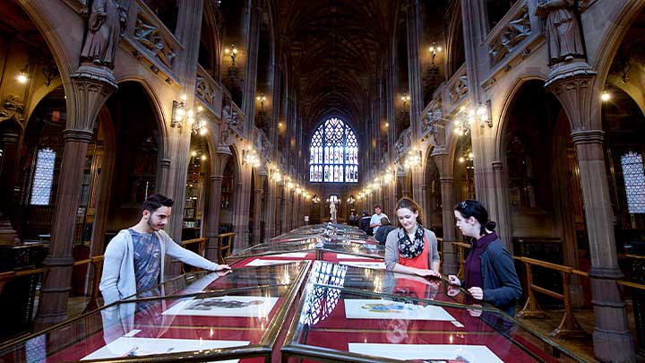 Students reading ancient texts in John Rylands Library