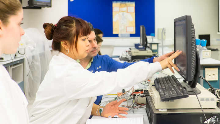 Two students using a computer in a laboratory.