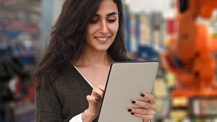 Female stood up working on her tablet