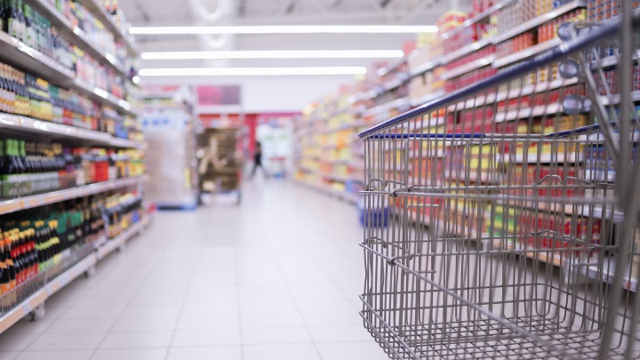 Shopping trolley in a supermarket aisle 