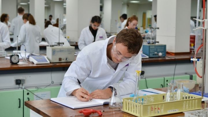 A student writing notes in the lab.