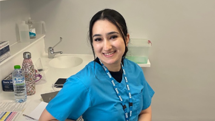 A dentistry student in uniform.