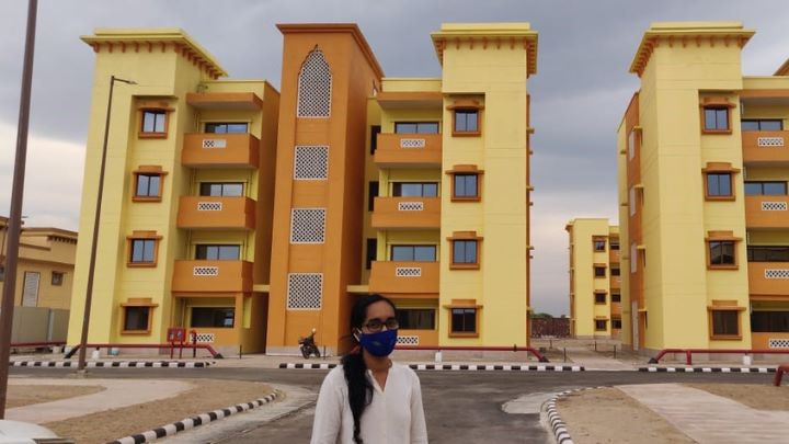 Student intern stod infront of a block of flats