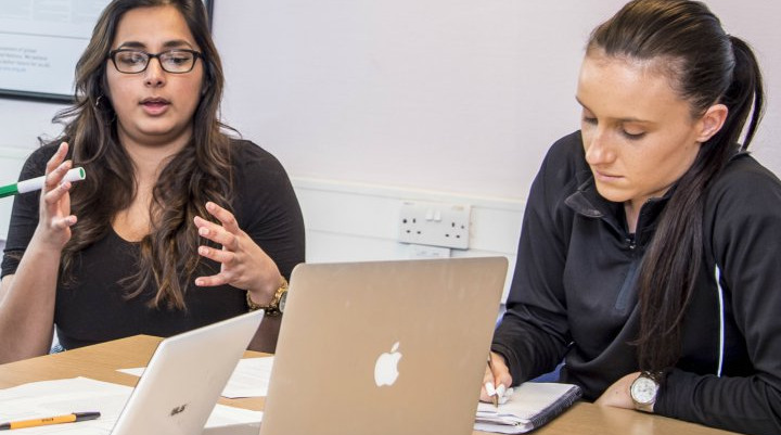 Two students working at a desk