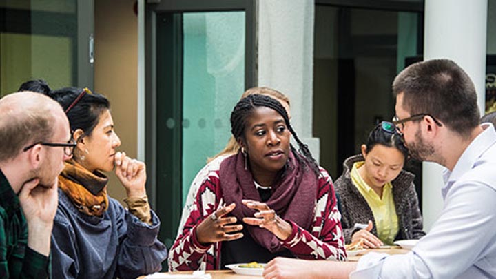 Group of people engaged in a work meeting in an open space