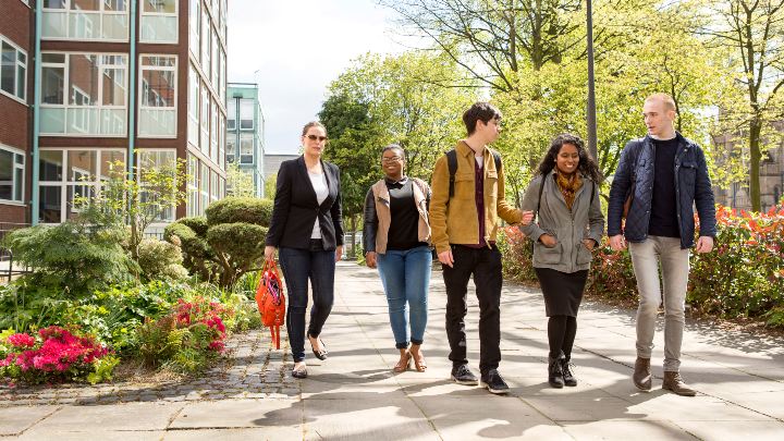 A group of students walking in Brunswick Park, Manchester