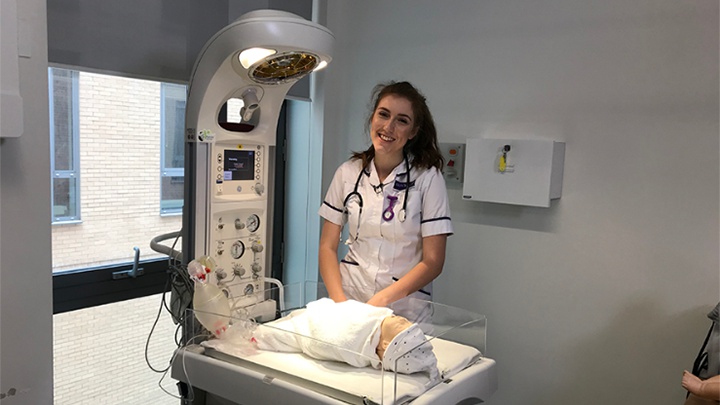 A midwifery student in a simulated patient room.