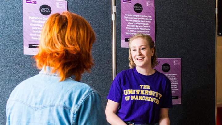 A student talking at an event stand