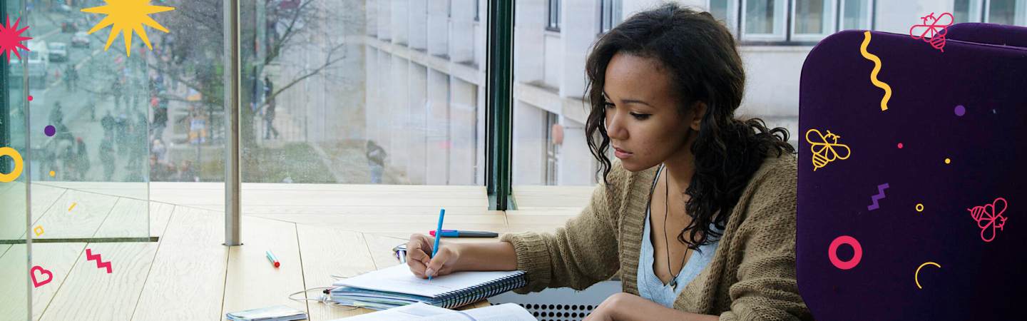 Girl sat by window writing notes